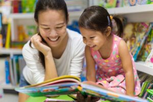 mom reading a book to her child